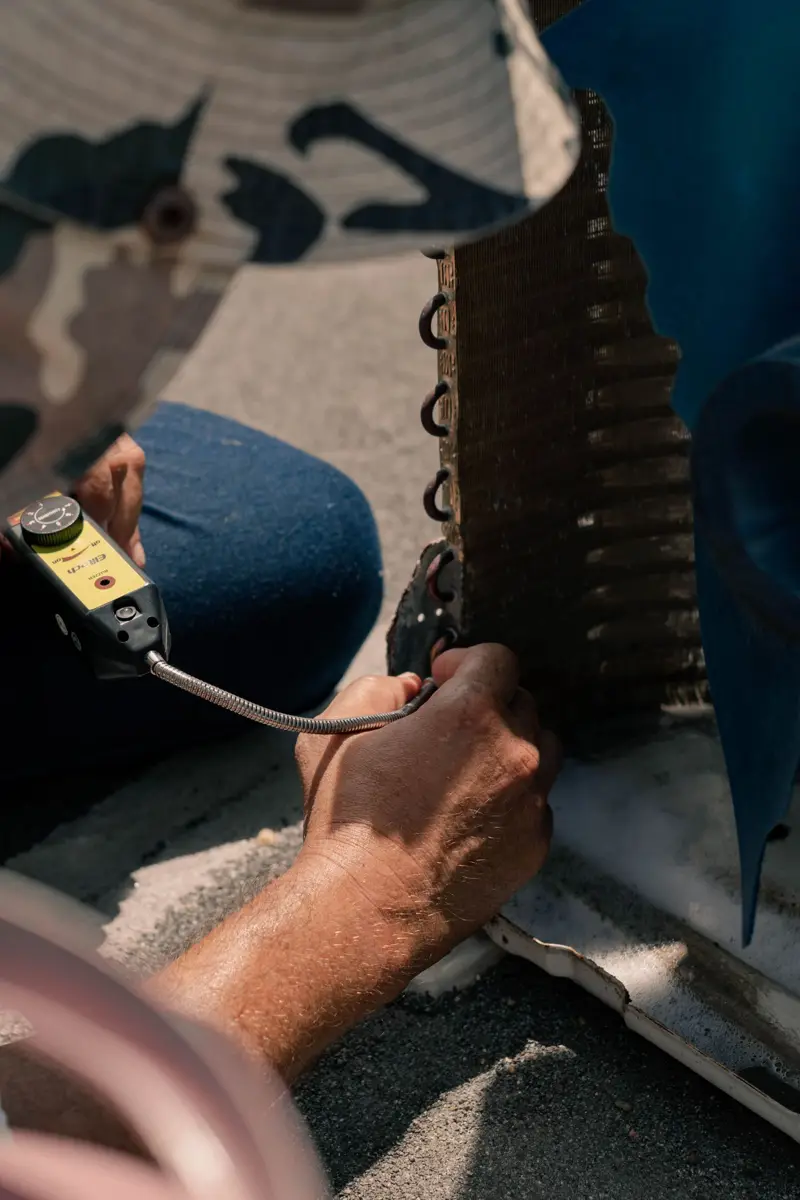 Technician repairing an AC unit